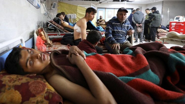 Palestinians who were wounded in Israeli fire while waiting for aid, according to health officials, lie on beds at Al Shifa hospital, amid the ongoing conflict between Israel and Hamas, in Gaza City