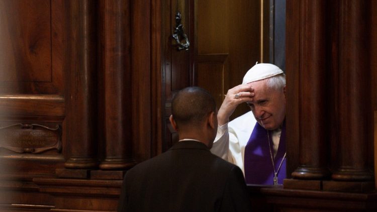 Pope Francis hears a confession during a meeting with the clergy of Rome at the Basilica of St. John in Lateran in Rome